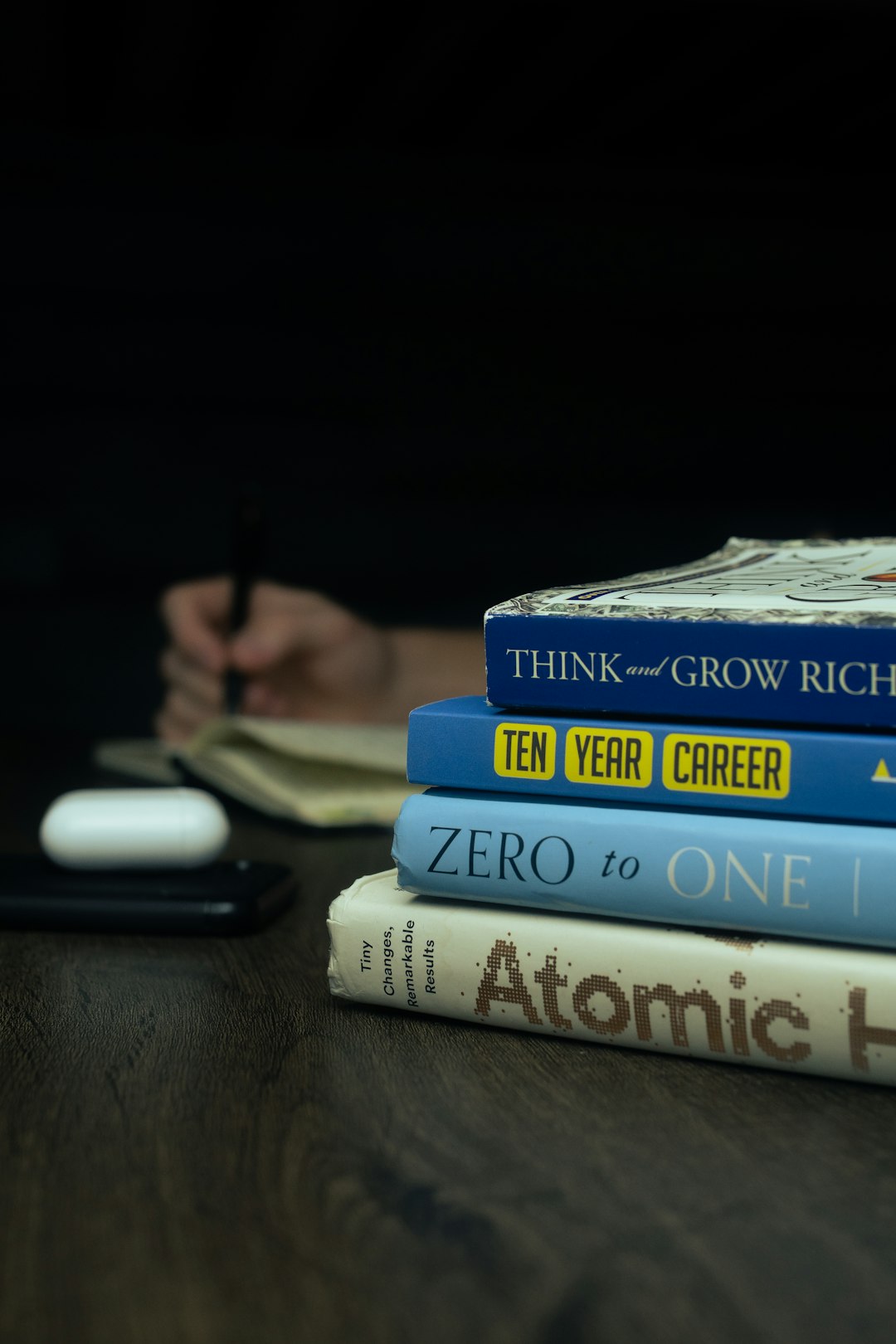 a-stack-of-books-sitting-on-top-of-a-wooden-table-4owvk0y3auc